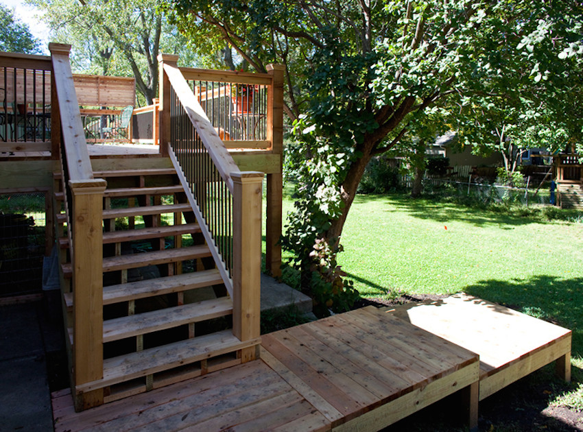 This is an example of a mid-sized traditional backyard deck in Kansas City with no cover.