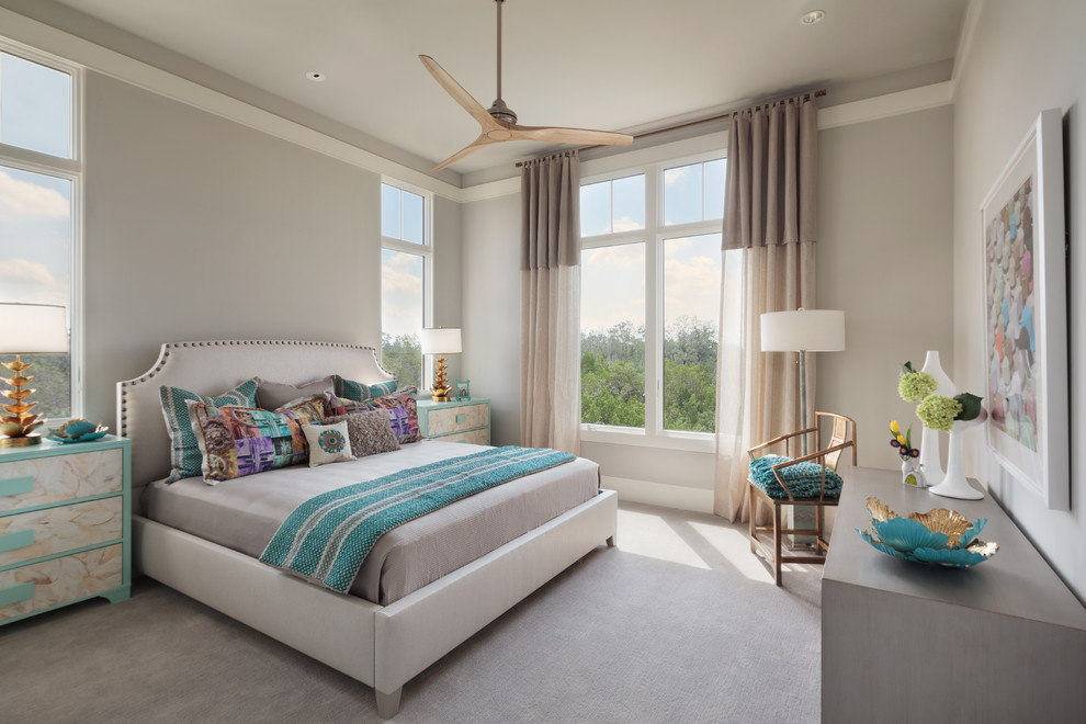 This is an example of a transitional bedroom in Miami with grey walls and carpet.