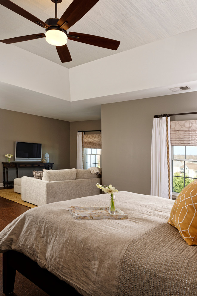 This is an example of a large transitional master bedroom in DC Metro with grey walls and cork floors.