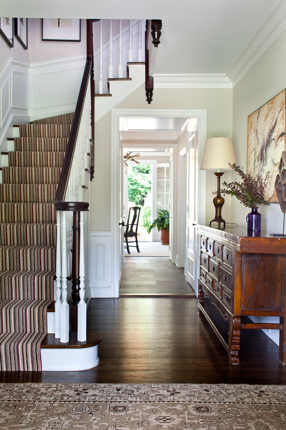 This is an example of a mid-sized eclectic entry hall in New York with beige walls, dark hardwood floors and brown floor.