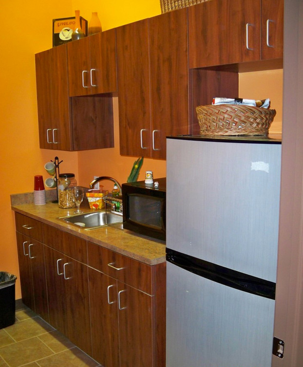 Kitchen - kitchen idea with flat-panel cabinets and medium tone wood cabinets
