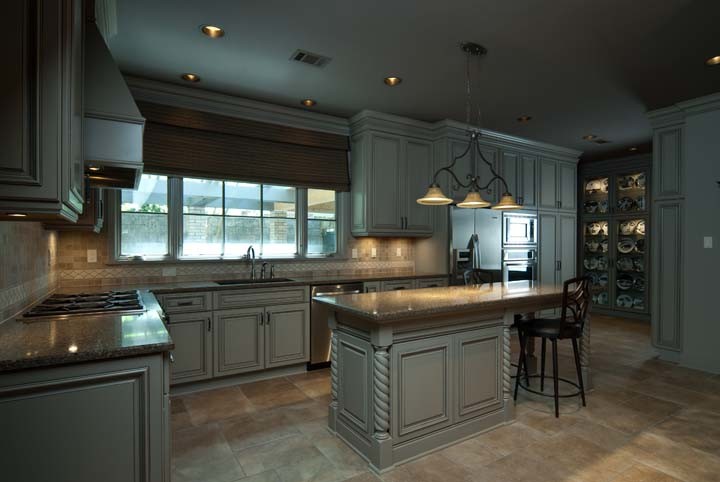Example of a small l-shaped ceramic tile kitchen design with a single-bowl sink, flat-panel cabinets, gray cabinets and stainless steel appliances