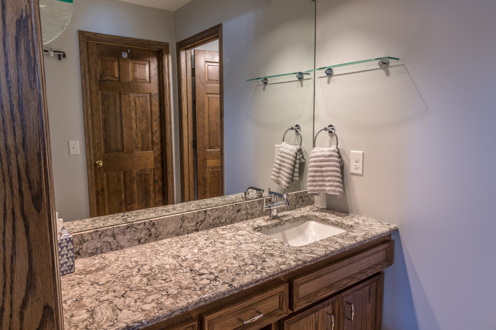 Photo of a large transitional master bathroom in Minneapolis with a freestanding tub, a corner shower, a one-piece toilet, beige tile, ceramic tile, grey walls, porcelain floors, an undermount sink, engineered quartz benchtops, multi-coloured floor, a hinged shower door and beige benchtops.