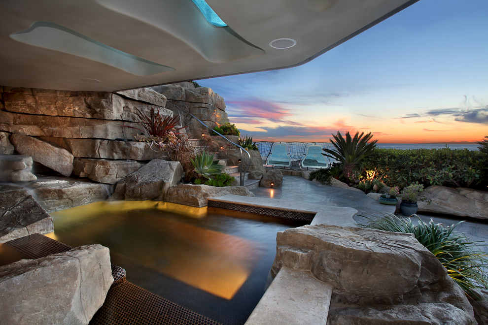 Inspiration for an eclectic custom-shaped pool in Orange County with a hot tub.