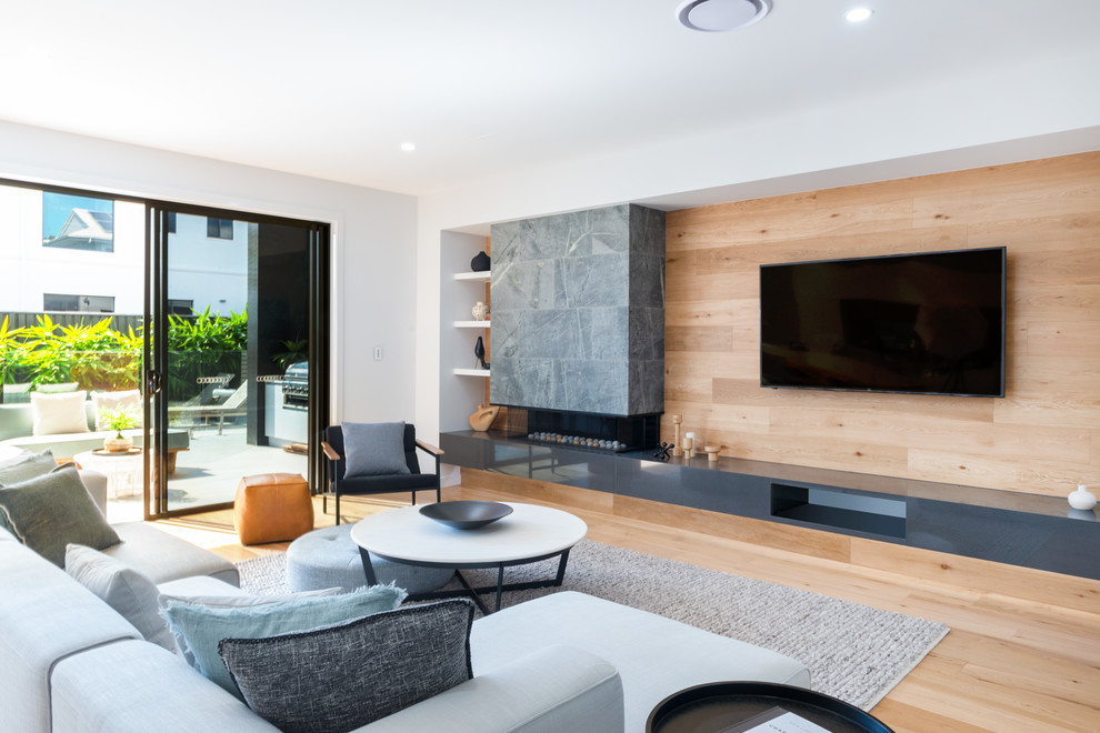 Contemporary open concept living room in Brisbane with white walls, light hardwood floors, a ribbon fireplace, a tile fireplace surround and beige floor.