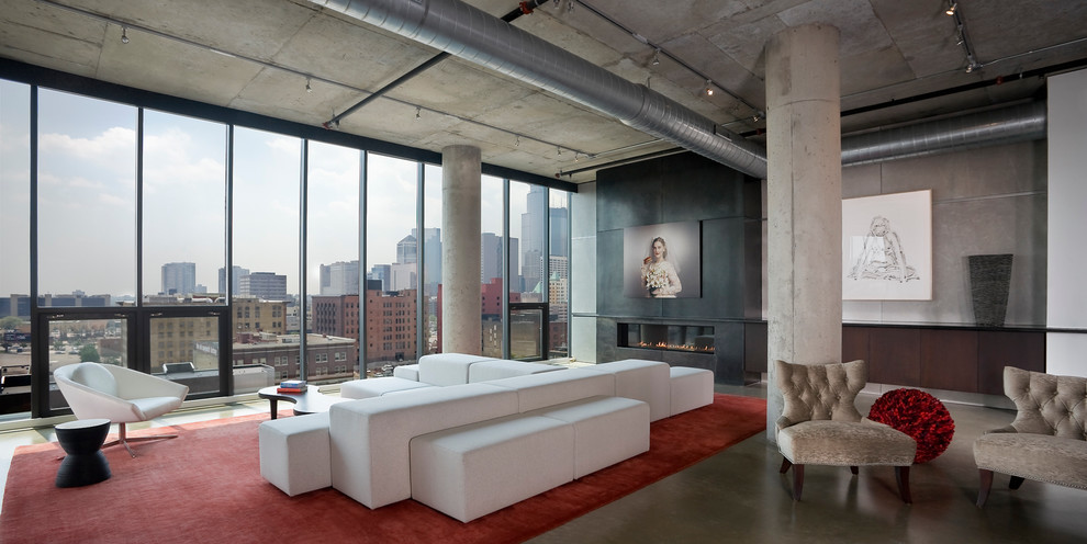 Design ideas for a large industrial open concept living room in Minneapolis with grey walls, concrete floors, a ribbon fireplace and a concrete fireplace surround.