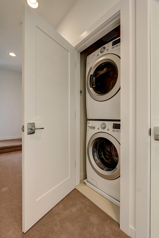 This is an example of a small contemporary single-wall laundry cupboard in Seattle.
