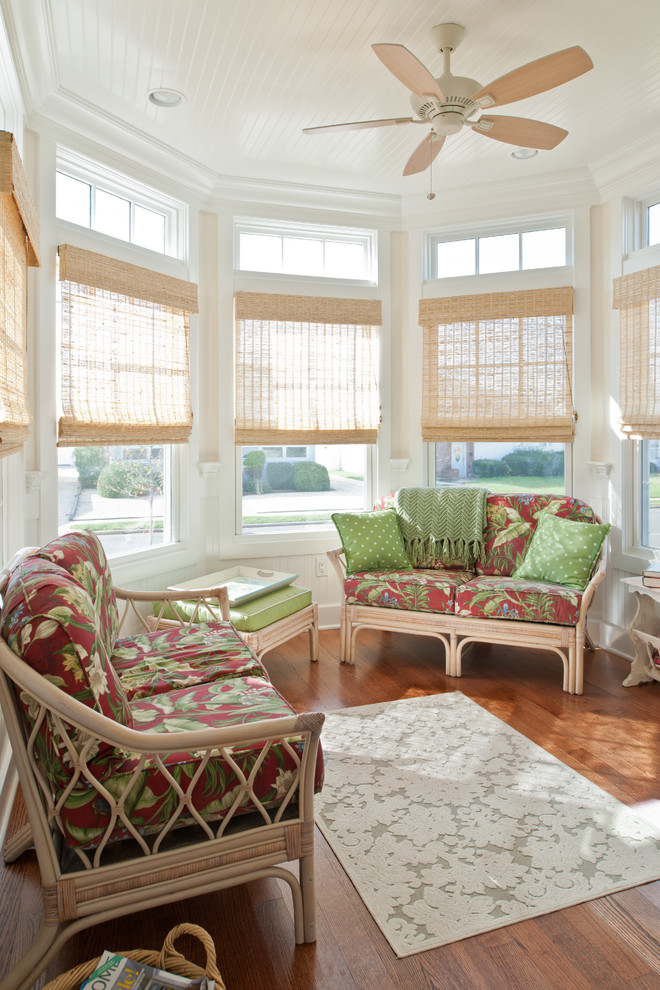 Photo of a mid-sized beach style sunroom in New York with medium hardwood floors, no fireplace and a standard ceiling.