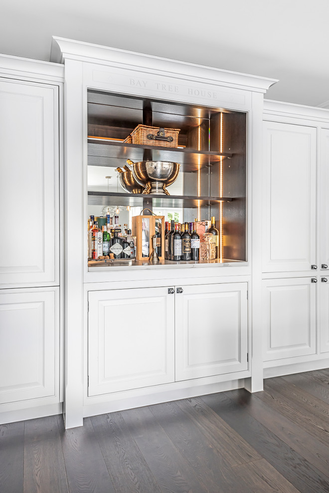 Photo of a large traditional home bar in Berkshire with shaker cabinets, grey cabinets, quartzite benchtops, brown floor and white benchtop.