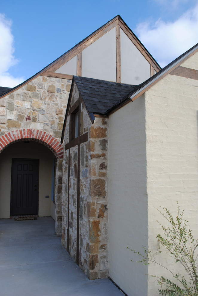 Photo of a large mediterranean one-storey brick red exterior in Austin with a gable roof.