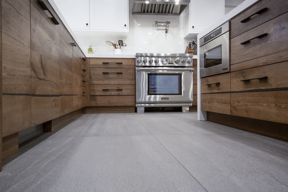 Contemporary kitchen with flat-panel cabinets, medium wood cabinets, quartz benchtops, white splashback, panelled appliances and white benchtop.