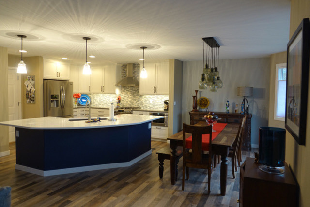 Inspiration for a mid-sized transitional eat-in kitchen remodel in Seattle with an undermount sink, shaker cabinets, quartzite countertops, glass tile backsplash, stainless steel appliances, an island and white countertops