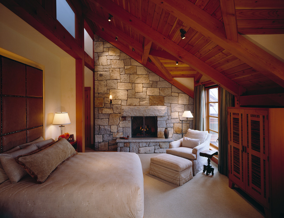 Design ideas for a large traditional master bedroom in Seattle with beige walls, carpet, a stone fireplace surround and a standard fireplace.