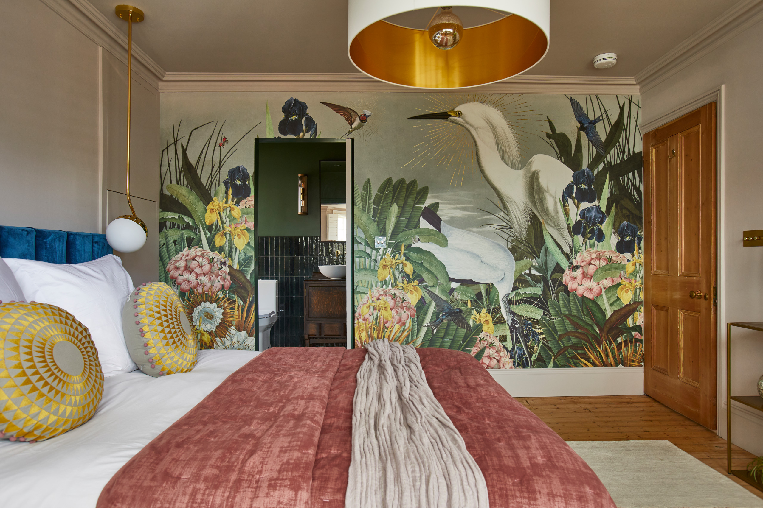 Example of a transitional bedroom design in Sussex