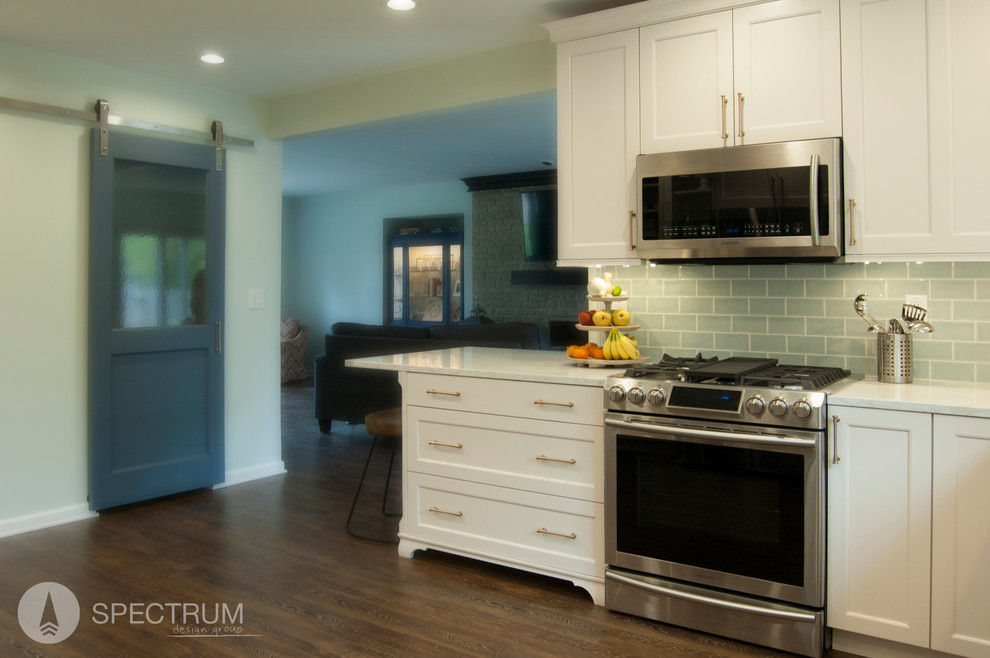 Eat-in kitchen - mid-sized transitional l-shaped dark wood floor eat-in kitchen idea in Chicago with a drop-in sink, raised-panel cabinets, white cabinets, granite countertops, green backsplash, subway tile backsplash, stainless steel appliances and an island