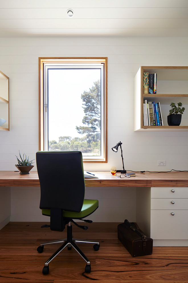 Study room in Geelong with light hardwood floors and a built-in desk.