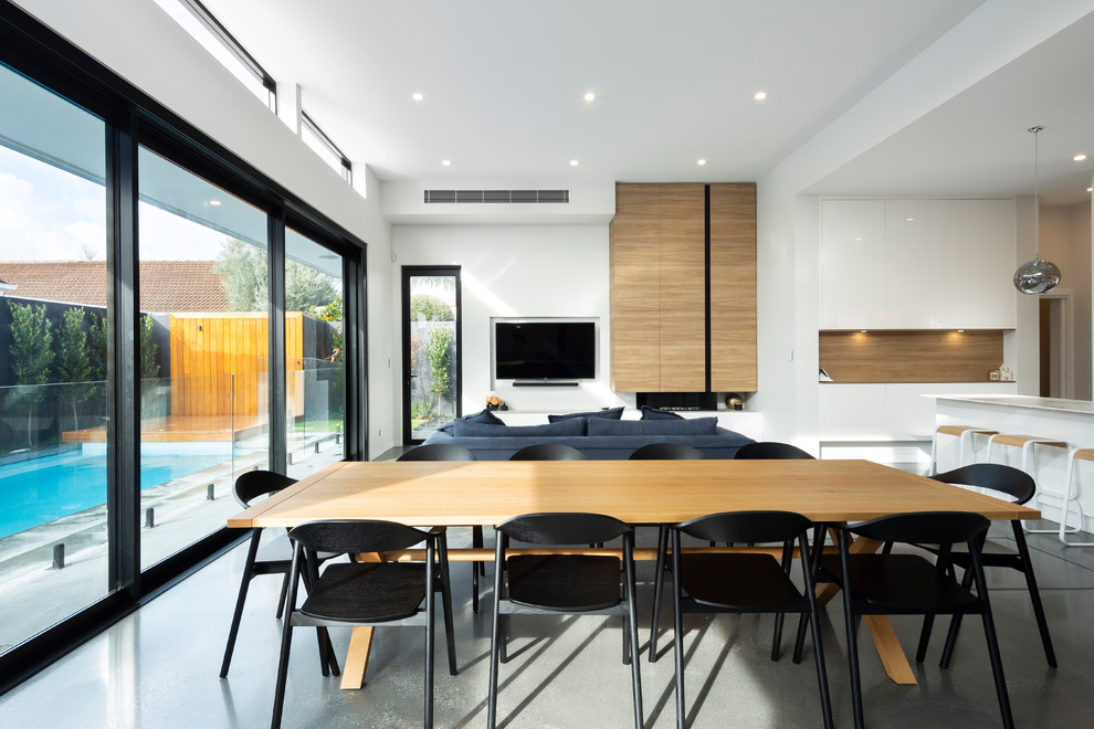 Design ideas for a contemporary dining room in Adelaide with white walls and grey floor.