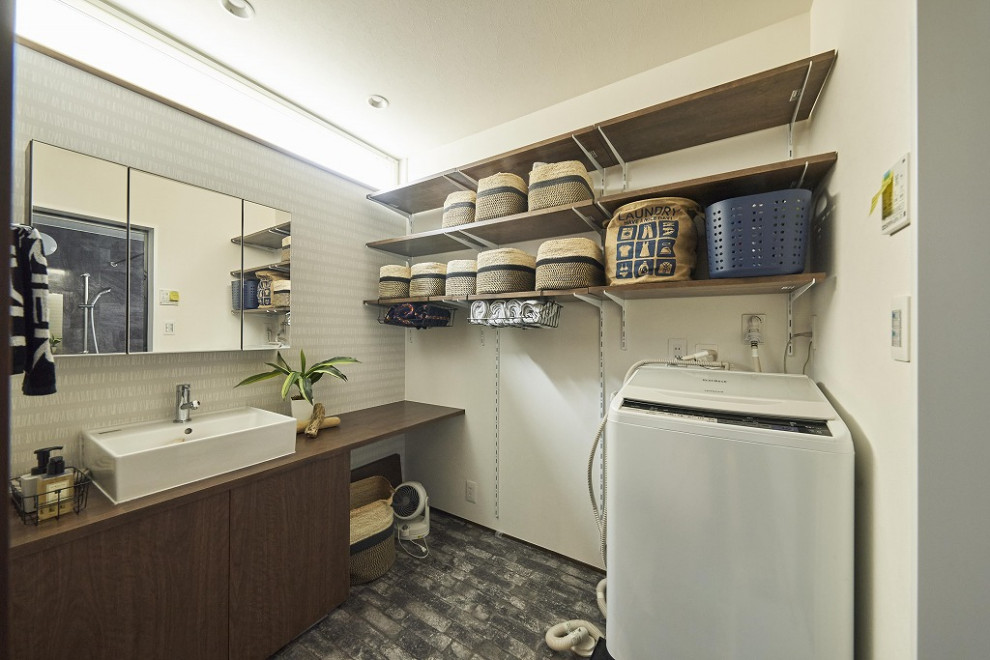 This is an example of a large modern laundry room in Tokyo with wood benchtops, white walls, vinyl floors, brown benchtop, wallpaper and wallpaper.