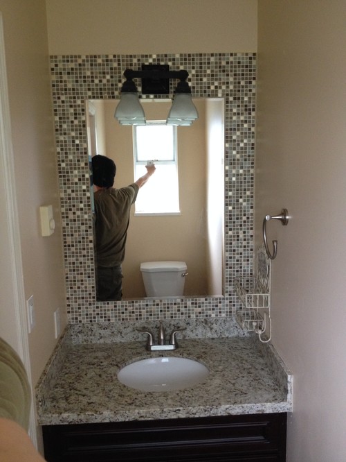 Build a mosaic tile mirror in the small bathroom. Good