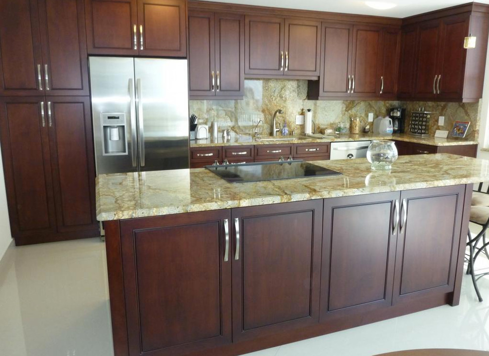 Example of a large transitional l-shaped marble floor and white floor open concept kitchen design in Orange County with an undermount sink, beaded inset cabinets, dark wood cabinets, granite countertops, beige backsplash, stone slab backsplash, stainless steel appliances and an island