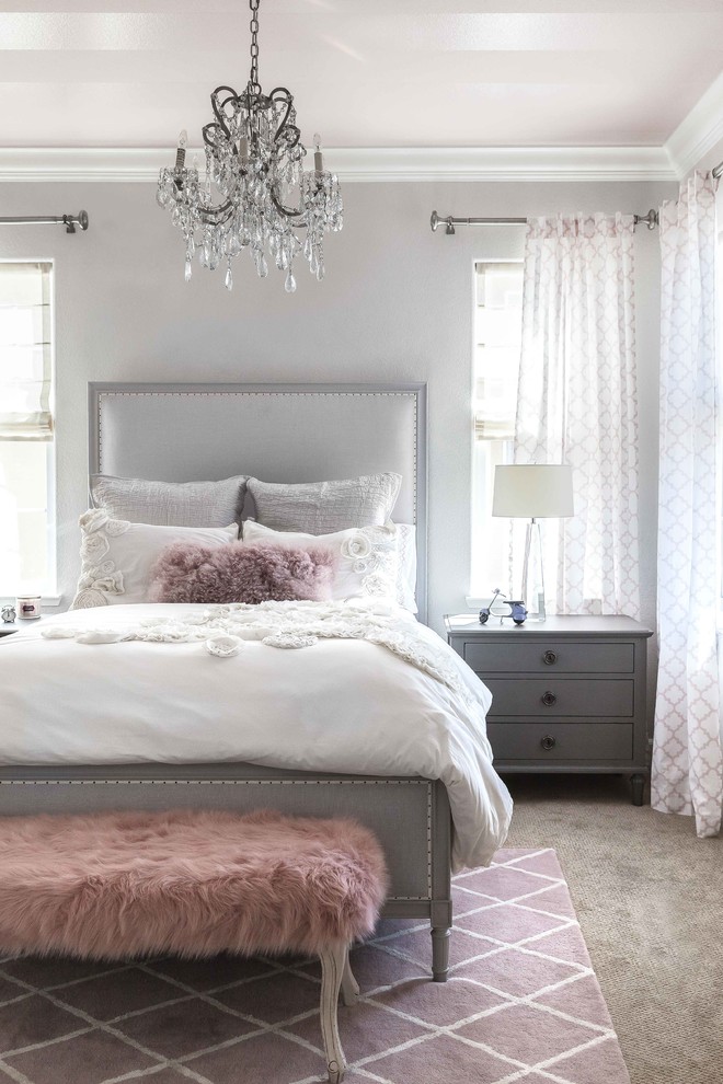 This is an example of a transitional bedroom in Sacramento with grey walls.