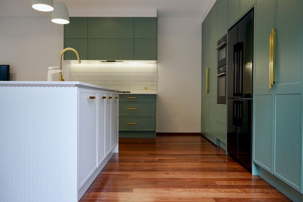 Inspiration for a large modern l-shaped open plan kitchen in Sydney with an undermount sink, shaker cabinets, turquoise cabinets, marble benchtops, white splashback, matchstick tile splashback, black appliances, dark hardwood floors, with island, brown floor and white benchtop.