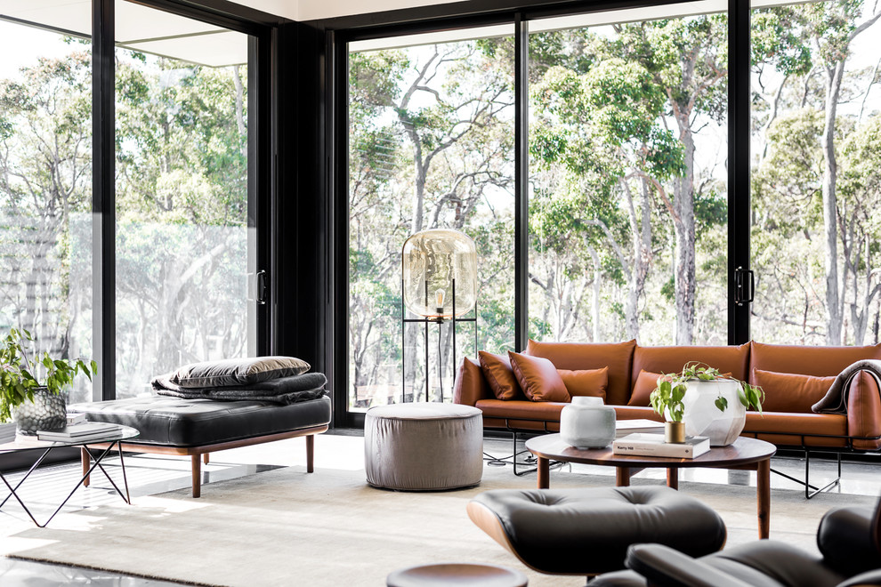 Photo of a contemporary living room in Perth with white walls, concrete floors and black floor.