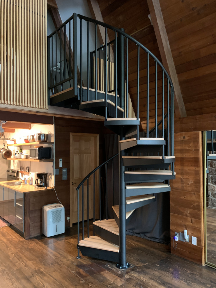 Mid-sized mountain style wooden spiral metal railing staircase photo in Portland with metal risers