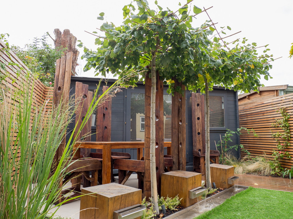 This is an example of a small contemporary backyard garden in London with concrete pavers.