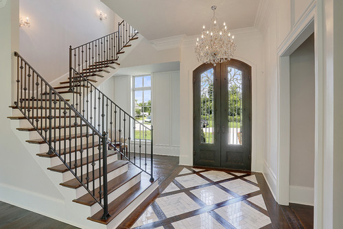 Large traditional foyer in New Orleans with white walls, ceramic floors, a single front door and a brown front door.