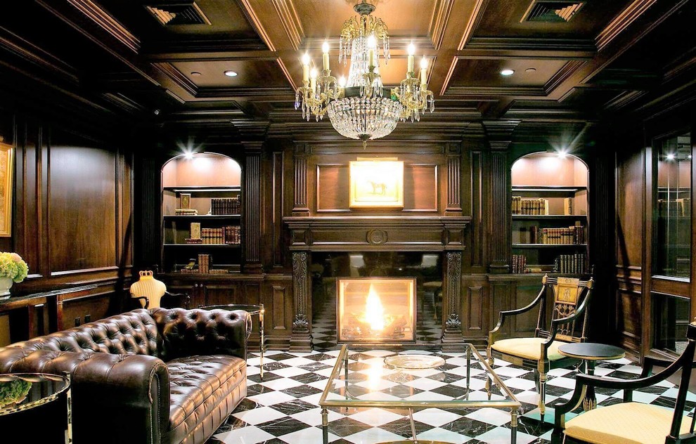 This is an example of a large traditional home office in New York with a library, brown walls, ceramic floors, a standard fireplace, a stone fireplace surround, a freestanding desk and white floor.