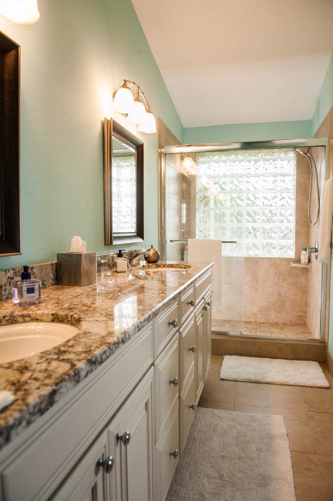 Inspiration for a mid-sized transitional master beige tile and ceramic tile ceramic tile alcove shower remodel in Miami with raised-panel cabinets, white cabinets, a two-piece toilet, blue walls, an undermount sink and granite countertops