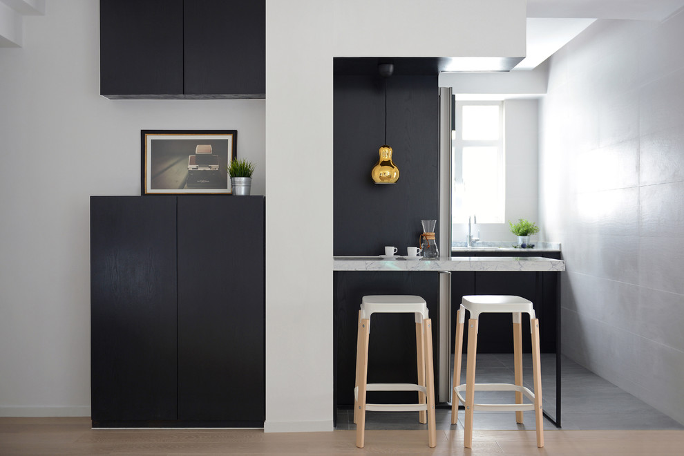 Design ideas for a small scandinavian l-shaped kitchen in Hong Kong with flat-panel cabinets, black cabinets and no island.