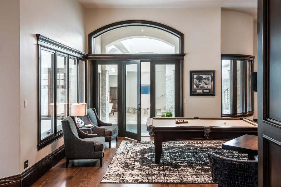 This is an example of a mid-sized transitional open concept family room in Salt Lake City with a game room, grey walls, dark hardwood floors, no tv and brown floor.