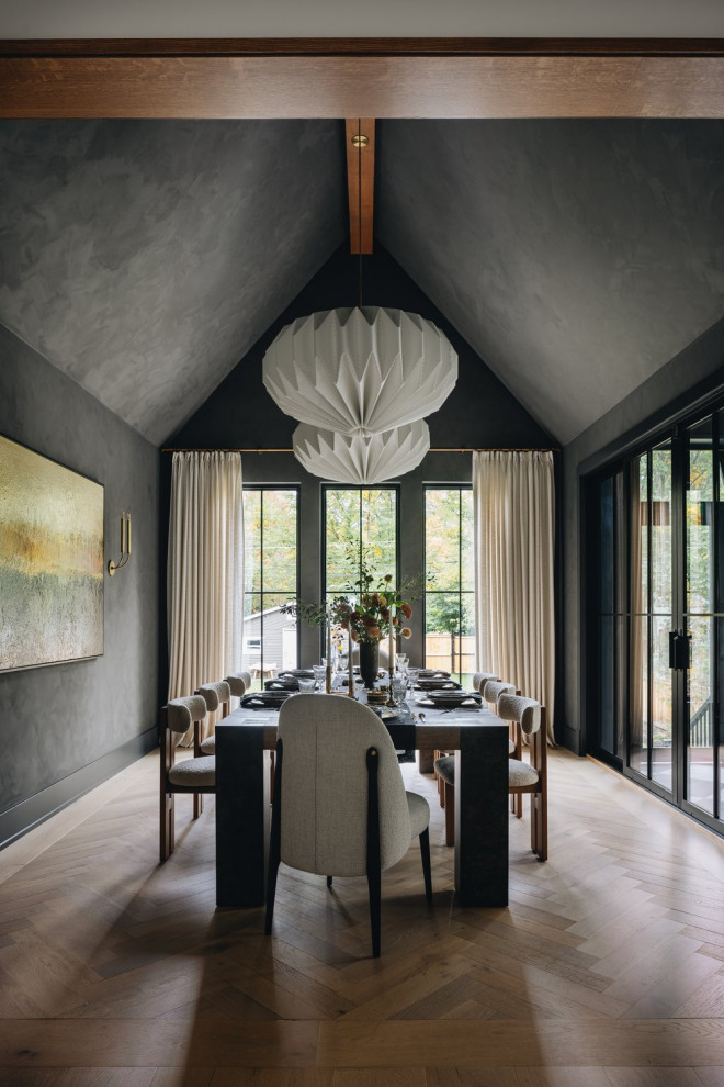 Example of a transitional medium tone wood floor, brown floor, exposed beam and vaulted ceiling dining room design in Chicago with gray walls