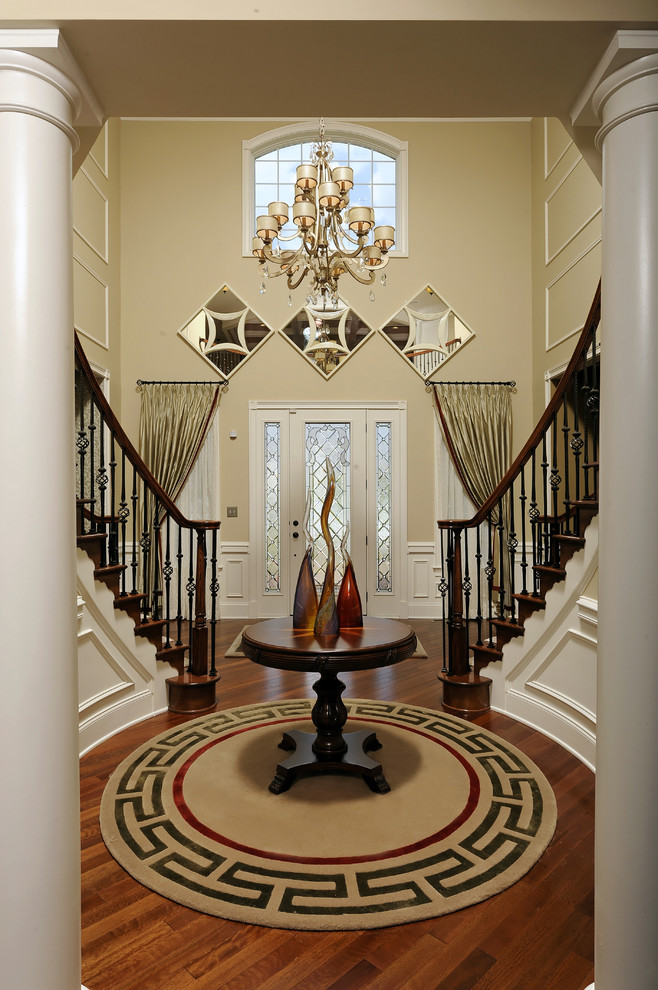 Large traditional foyer in DC Metro with beige walls.
