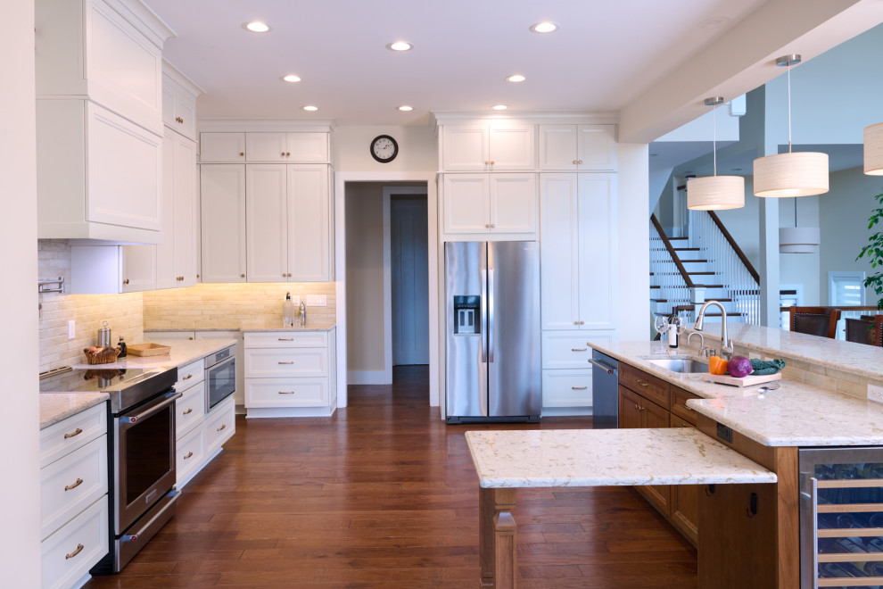 Huge transitional u-shaped open concept kitchen photo in DC Metro with a drop-in sink, recessed-panel cabinets, quartz countertops, multicolored backsplash, stainless steel appliances and an island