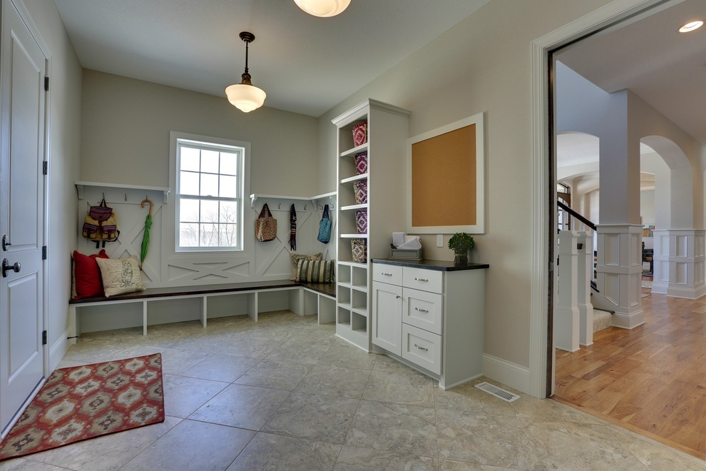 Photo of a large transitional mudroom in Minneapolis with beige walls, porcelain floors, a single front door and a white front door.