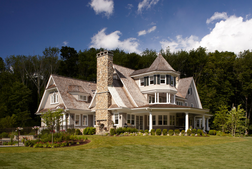 Large traditional three-storey grey exterior in New York with wood siding and a gable roof.