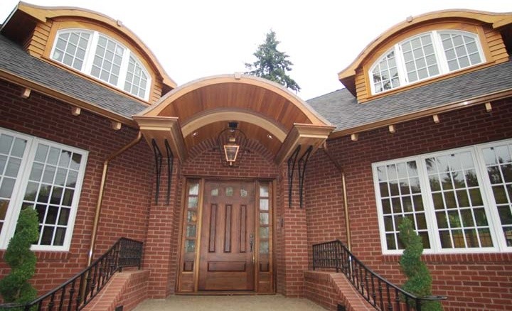 Photo of a large traditional three-storey brick exterior in Portland with a hip roof.