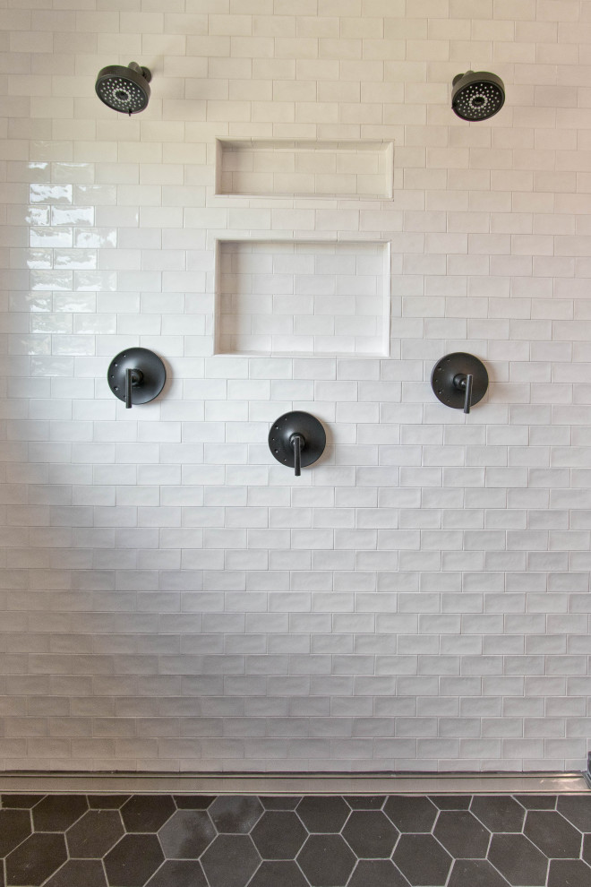 Minimalist master white tile and porcelain tile porcelain tile and black floor drop-in bathtub photo with white walls, white countertops and a niche