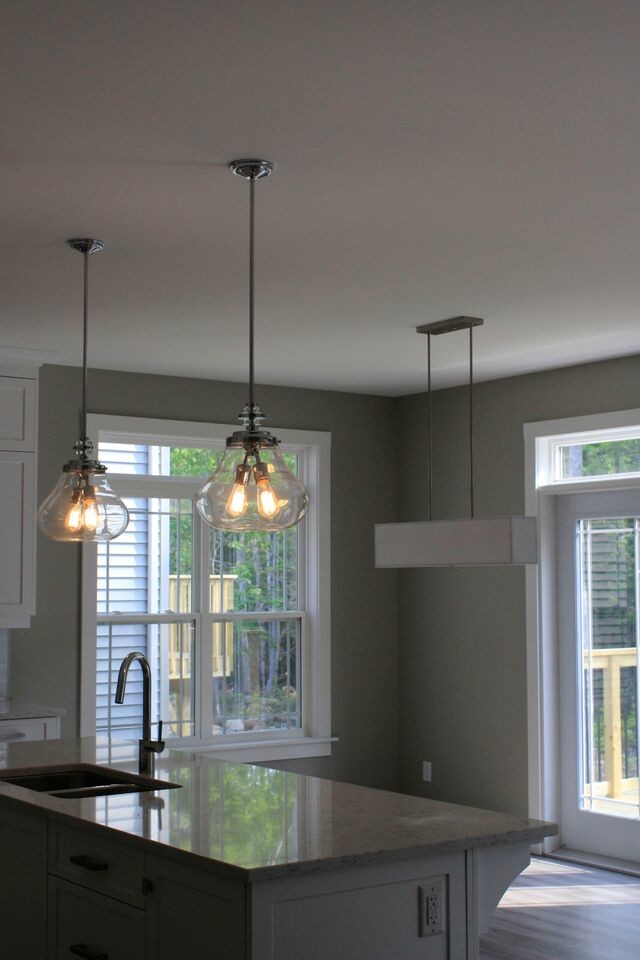 Mid-sized transitional l-shaped dark wood floor eat-in kitchen photo with a double-bowl sink, white cabinets, an island and quartz countertops
