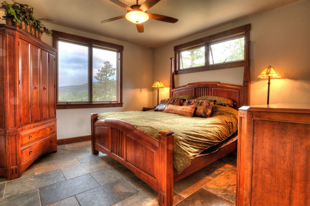 Design ideas for a mid-sized country master bedroom in Denver with slate floors.