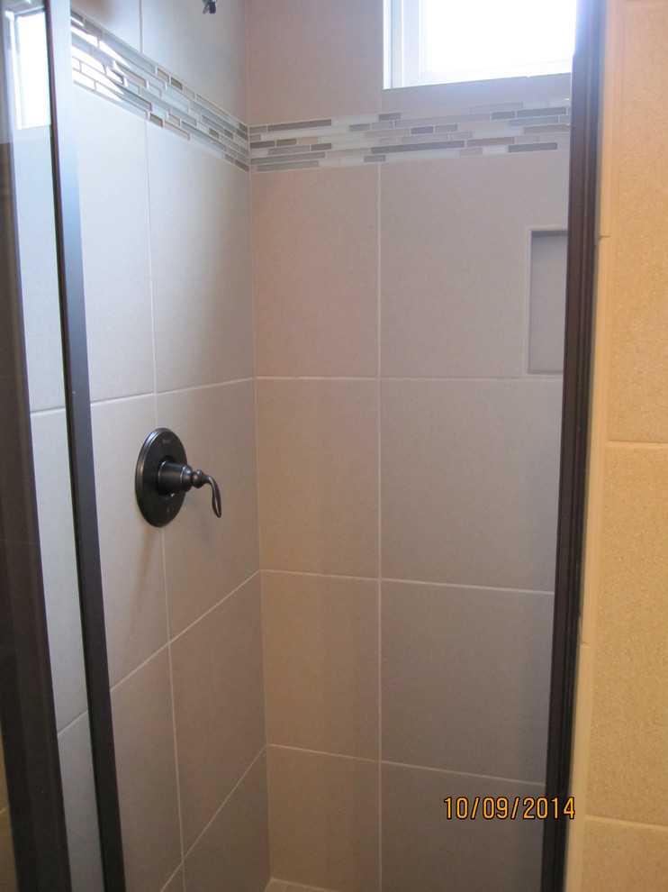 Inspiration for a mid-sized transitional 3/4 brown tile and porcelain tile porcelain tile home design remodel with an undermount sink, raised-panel cabinets, white cabinets, granite countertops, a one-piece toilet and beige walls