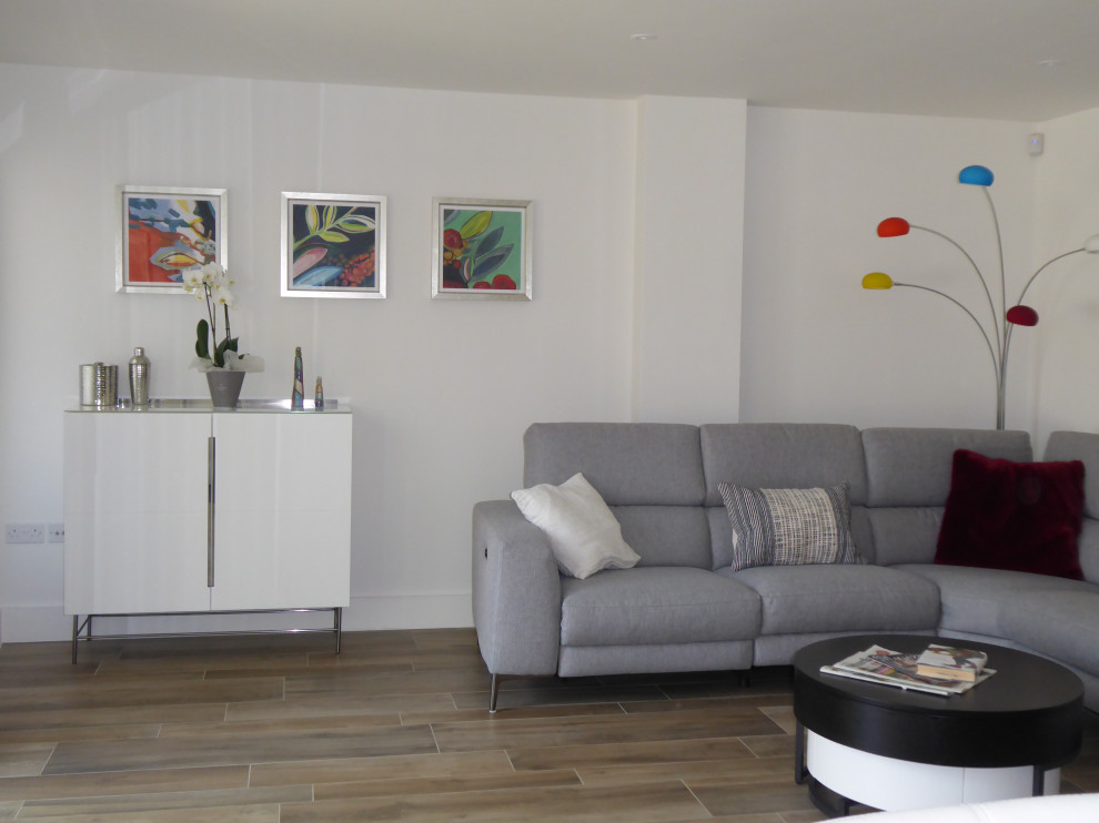 This is an example of a medium sized modern open plan games room in Dorset with white walls.