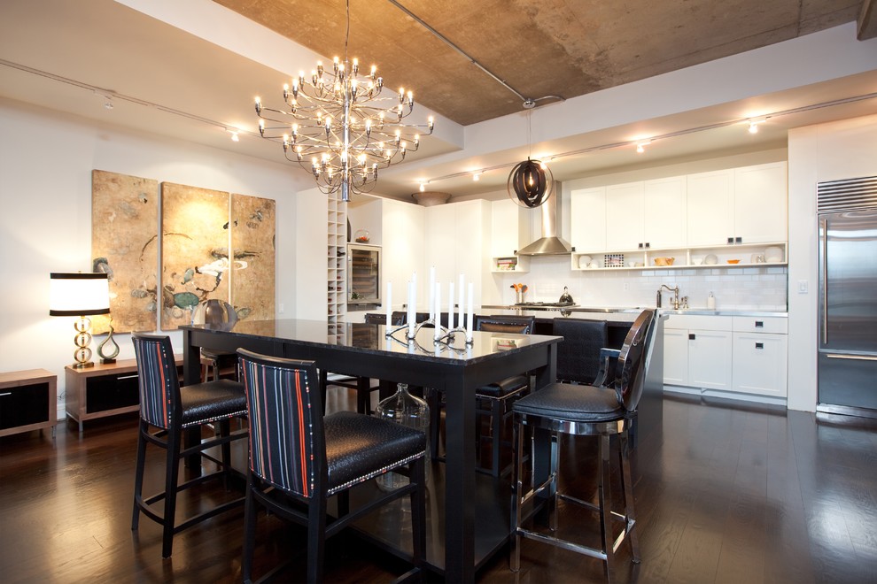 Photo of a large eclectic kitchen/dining combo in Toronto with white walls, dark hardwood floors and brown floor.