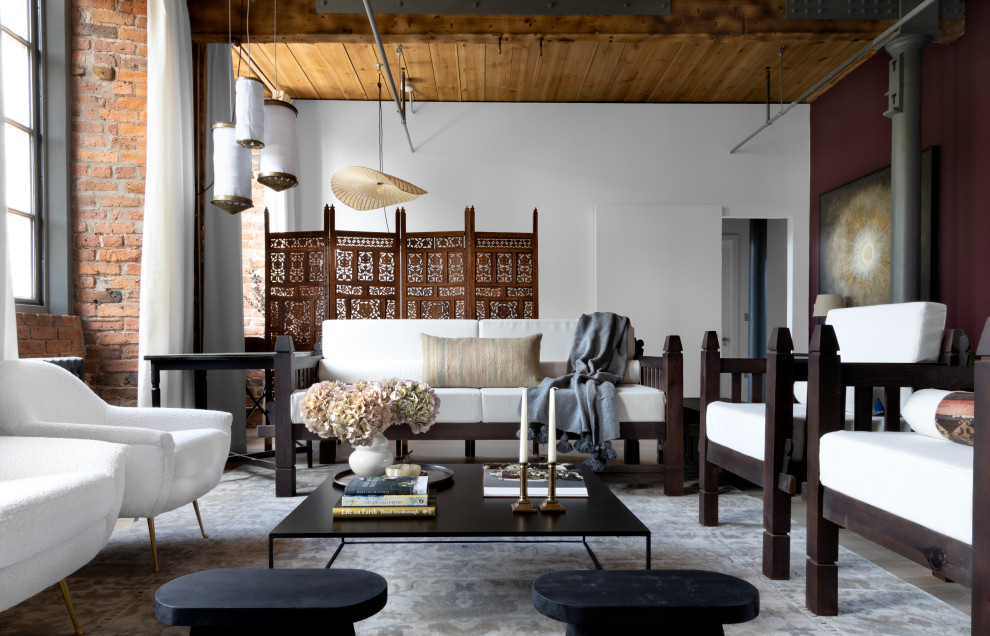 Photo of a large rustic grey and purple open plan living room in Manchester with purple walls, medium hardwood flooring, brown floors, exposed beams, brick walls and feature lighting.