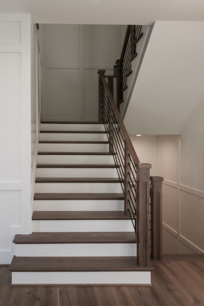 Inspiration for a large 1960s wooden floating mixed material railing staircase remodel in DC Metro with wooden risers