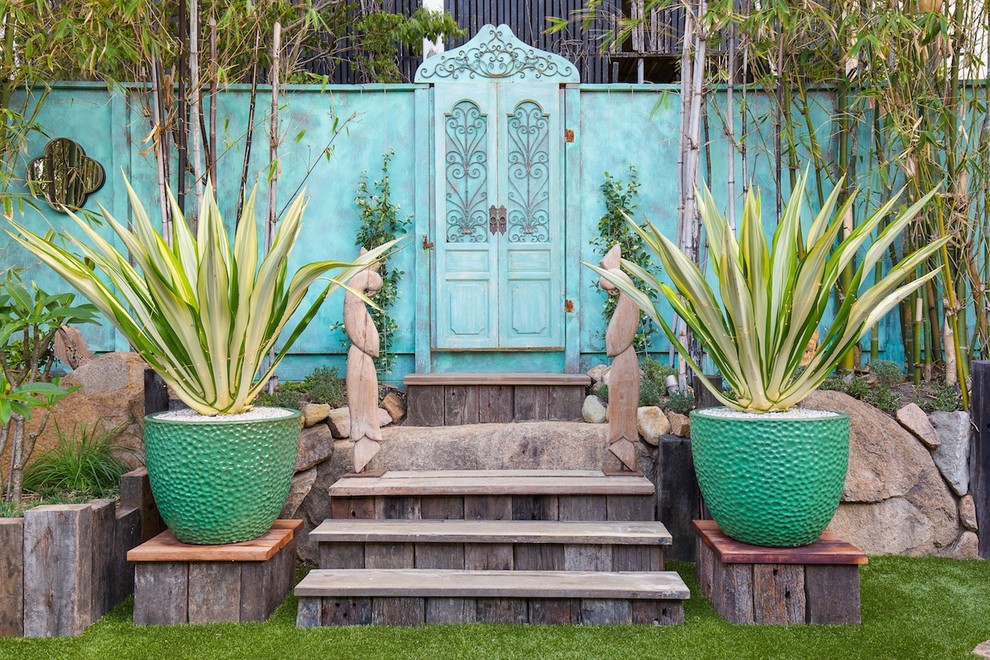 Traditional backyard partial sun garden in Brisbane with a container garden.