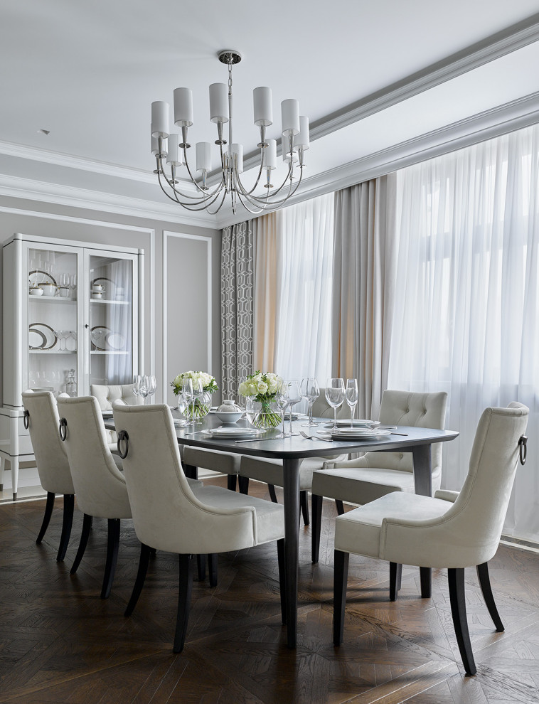 Traditional dining room in Moscow with grey walls, dark hardwood floors, recessed and panelled walls.